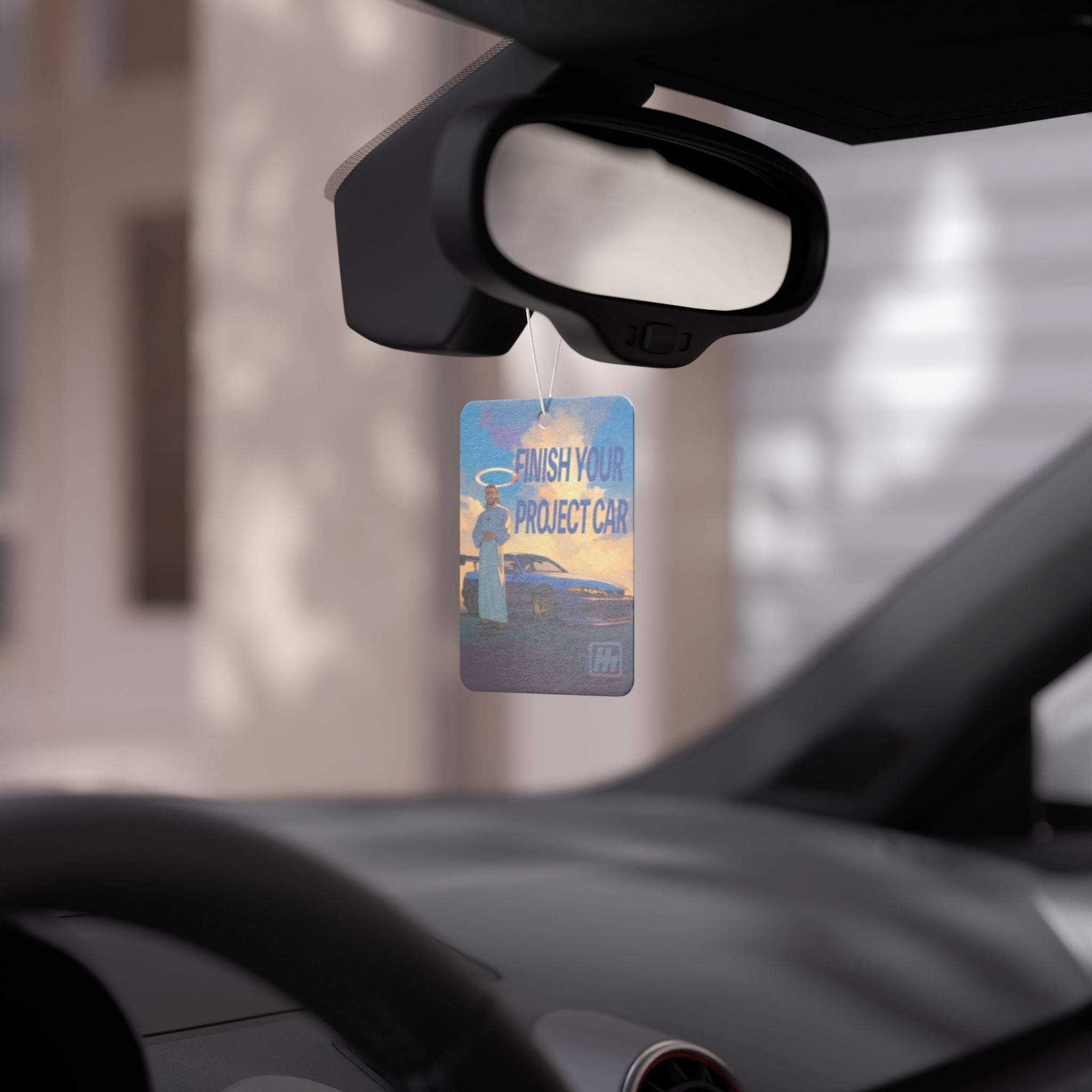 Premium car air freshener featuring a motivational "Finish Your Project Car" design with a car and halo figure background. Perfect for car enthusiasts looking to keep their ride smelling fresh and stylish.
