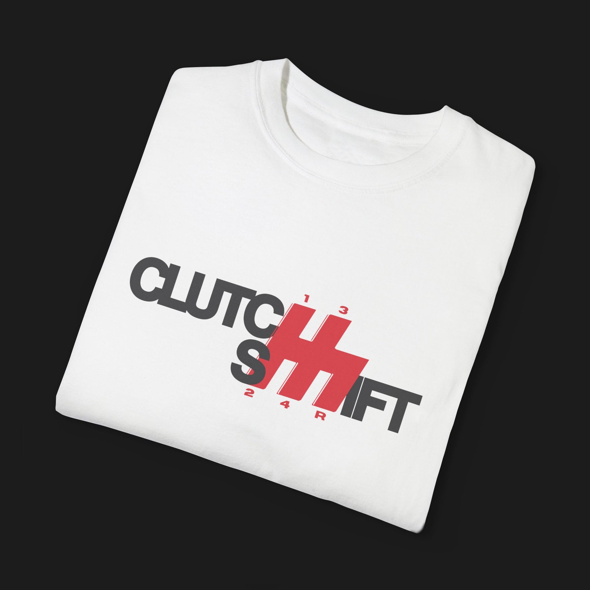 Folded Clutch Shift Automotive Graphic T-Shirt – White tee with "Clutch Shift" text and red gear shift design. Perfect gift for car enthusiasts and motorsport fans.