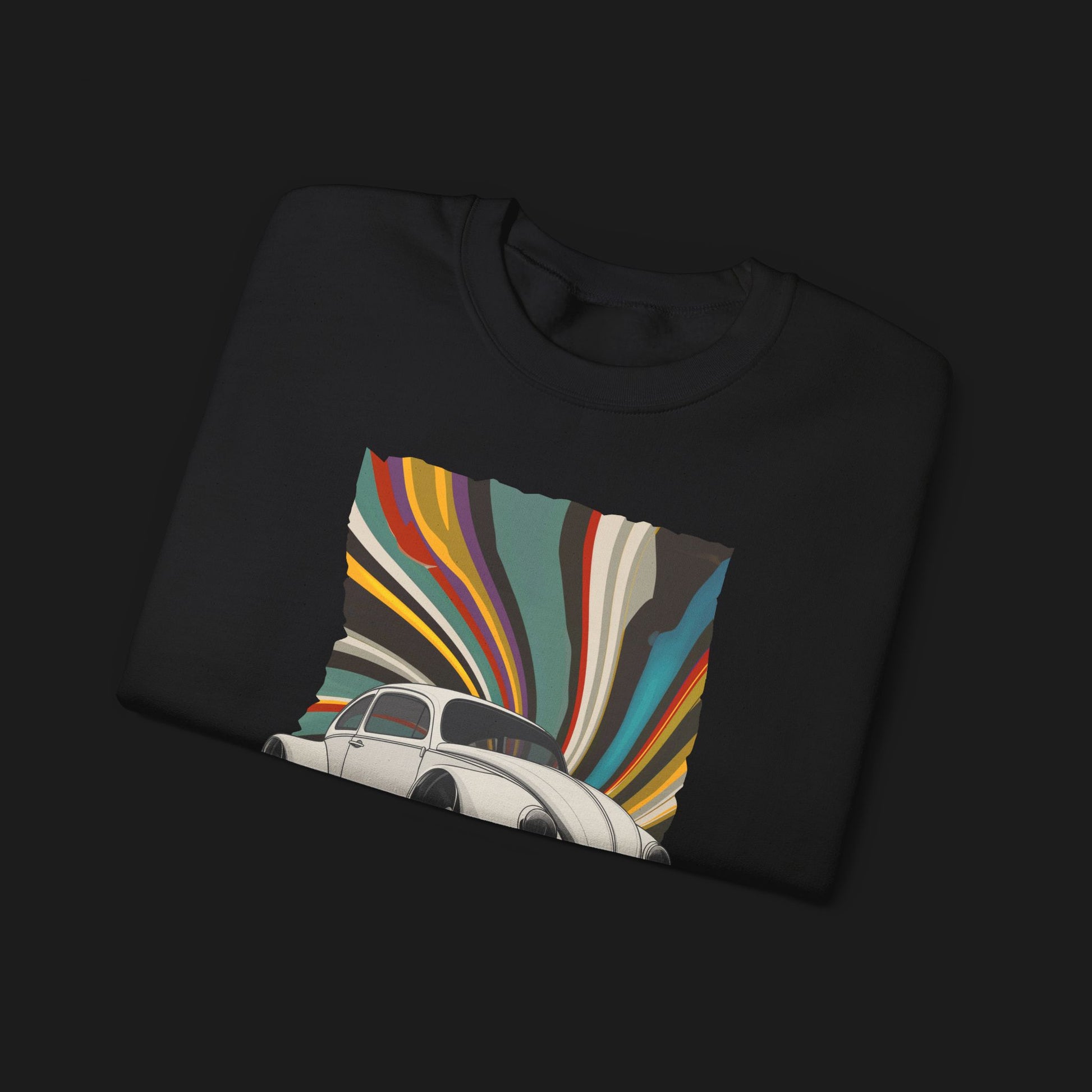 Folded Vintage Goods Bug Automotive Graphic Crewneck – Black unisex sweater featuring a classic Volkswagen Beetle with a colorful retro swirl background. Ideal for vintage car enthusiasts and retro style lovers.