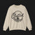 Front of Clutch Crewneck Automotive Sweater – Beige unisex sweater featuring a bold 'Clutch Clothing Shop' design with a tire tread circle and stylized text. Perfect for car enthusiasts and casual wear.