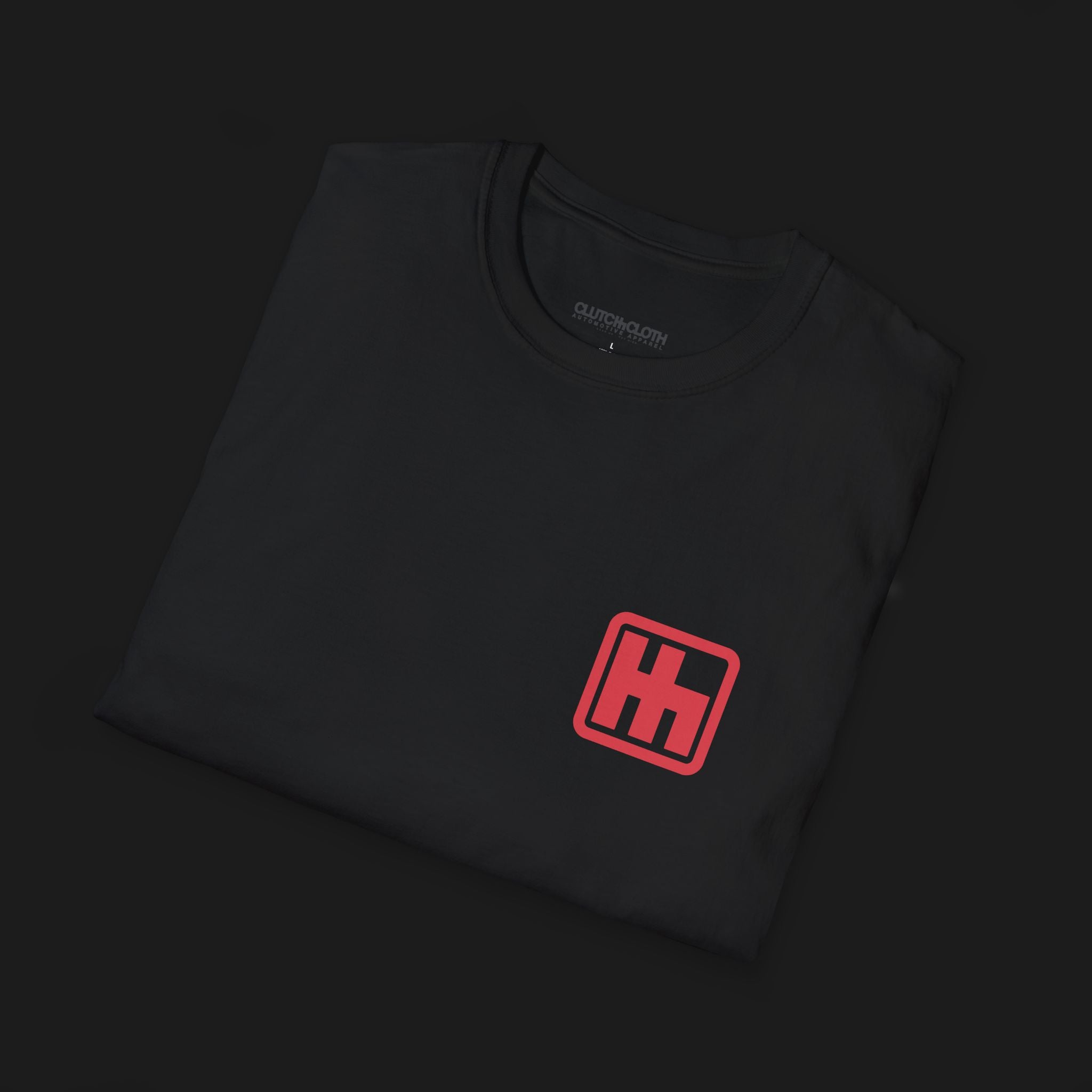 Folded Clutch Gated H Shifter Automotive Graphic T-Shirt – Black unisex tee with a minimalist red 'H' shifter logo on the left chest. Ideal gift for car enthusiasts and motorsport lovers.