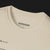 Collar of Define Clutch Automotive Graphic T-Shirt – Sand unisex tee featuring the definition of 'Clutch' in a minimalist text design. A perfect gift for car enthusiasts and motorsport fans.