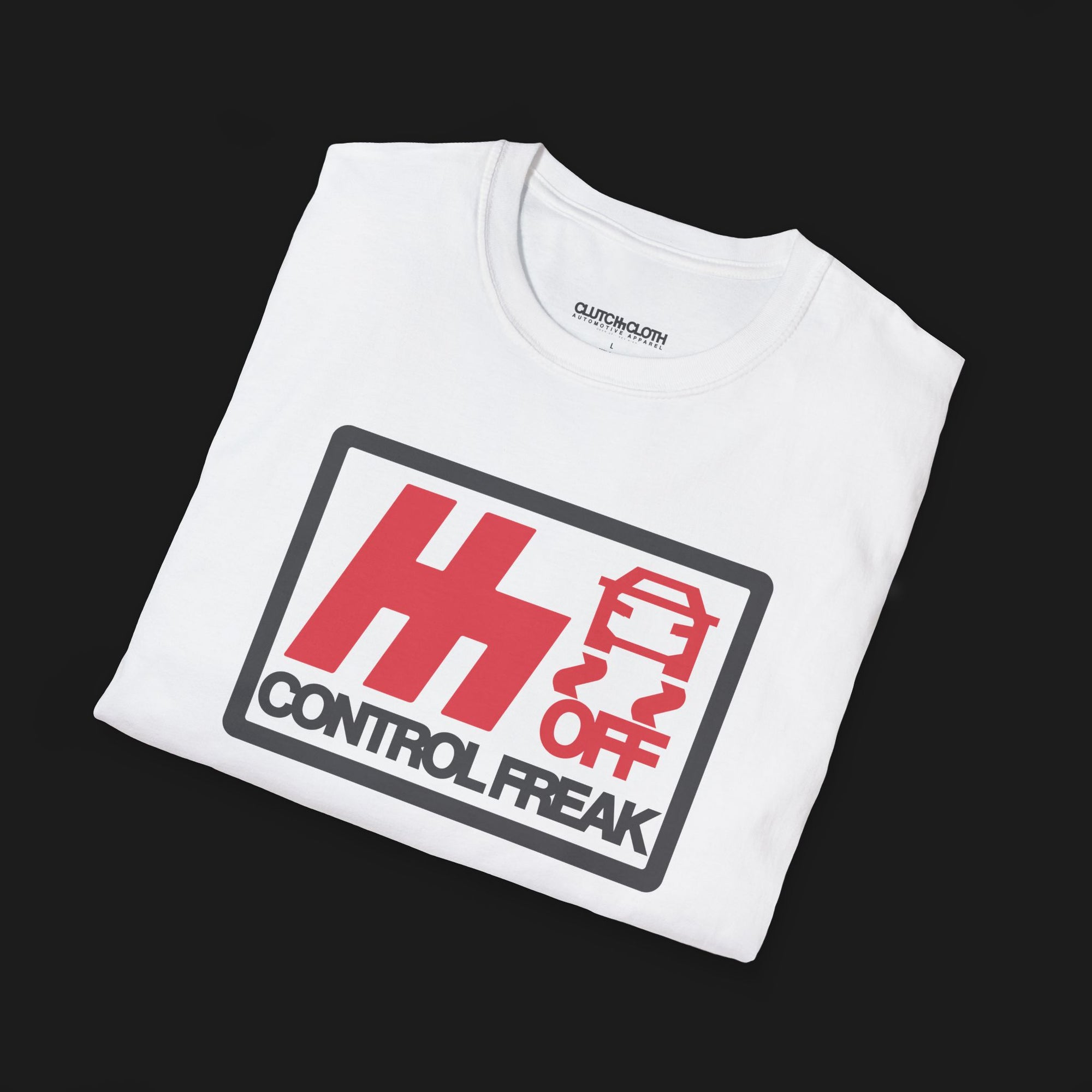 Folded Control Freak Automotive Graphic T-Shirt – White unisex tee with bold red 'H' logo, traction control off symbol, and 'Control Freak' text. Perfect gift for car lovers and driving enthusiasts.