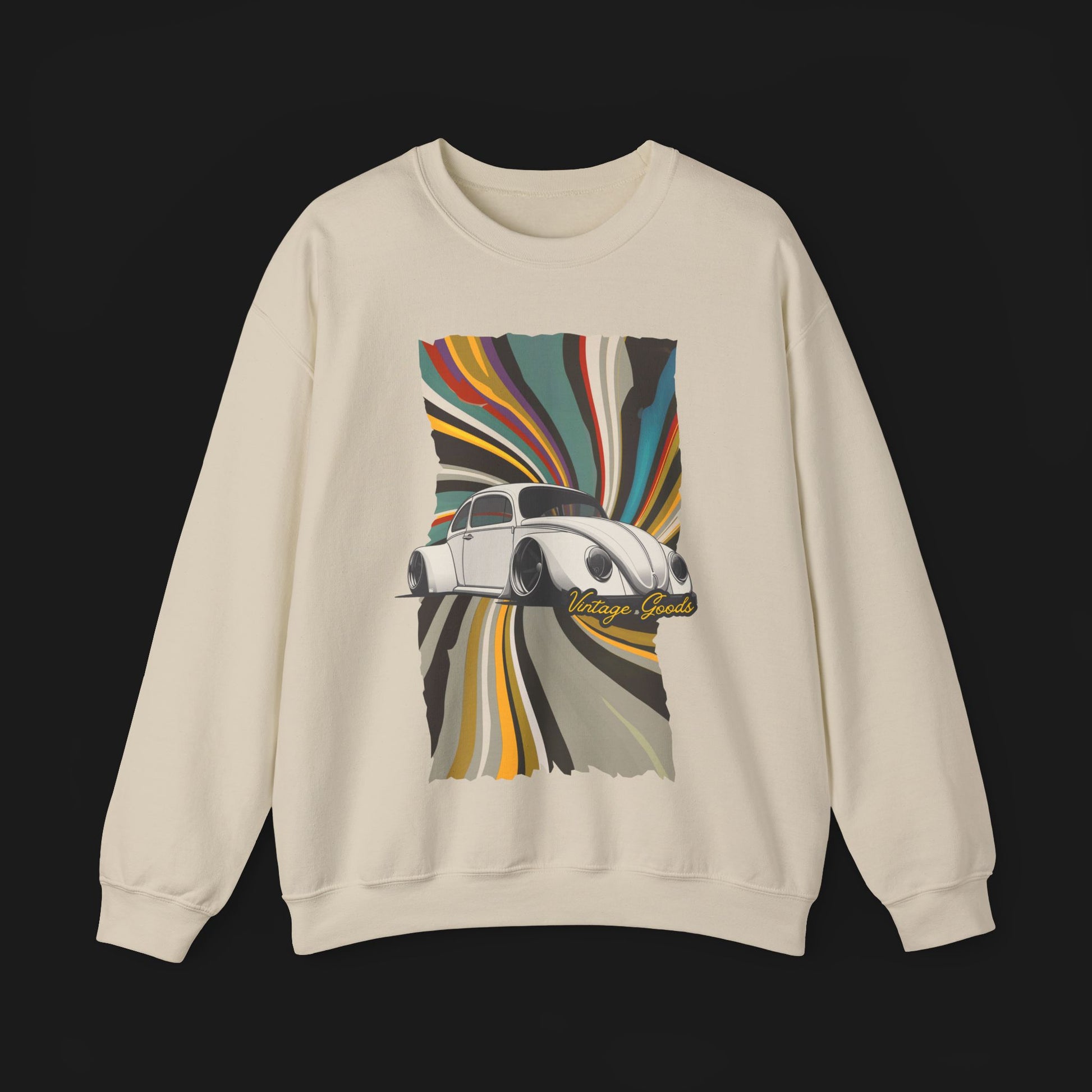 Vintage Goods Bug Automotive Graphic Crewneck – Beige unisex sweater featuring a classic Volkswagen Beetle with a colorful retro swirl background. Ideal for vintage car enthusiasts and retro style lovers.