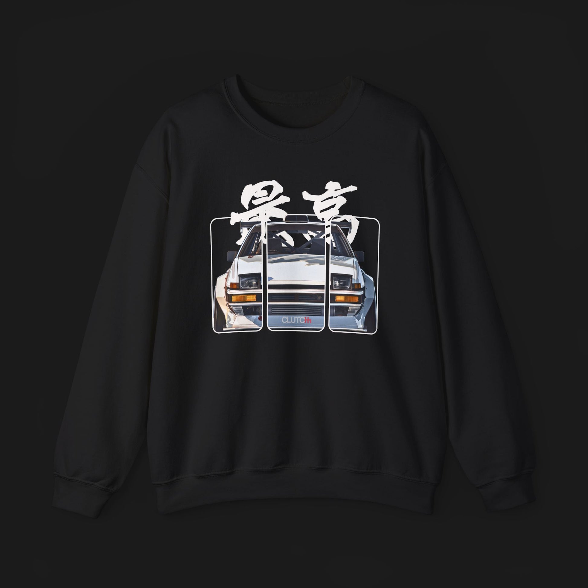 Front of AE86 Automotive Graphic Crewneck – Black unisex crewneck sweater featuring a front graphic of a white AE86 car with red Japanese text background design. Perfect for JDM enthusiasts and car lovers.