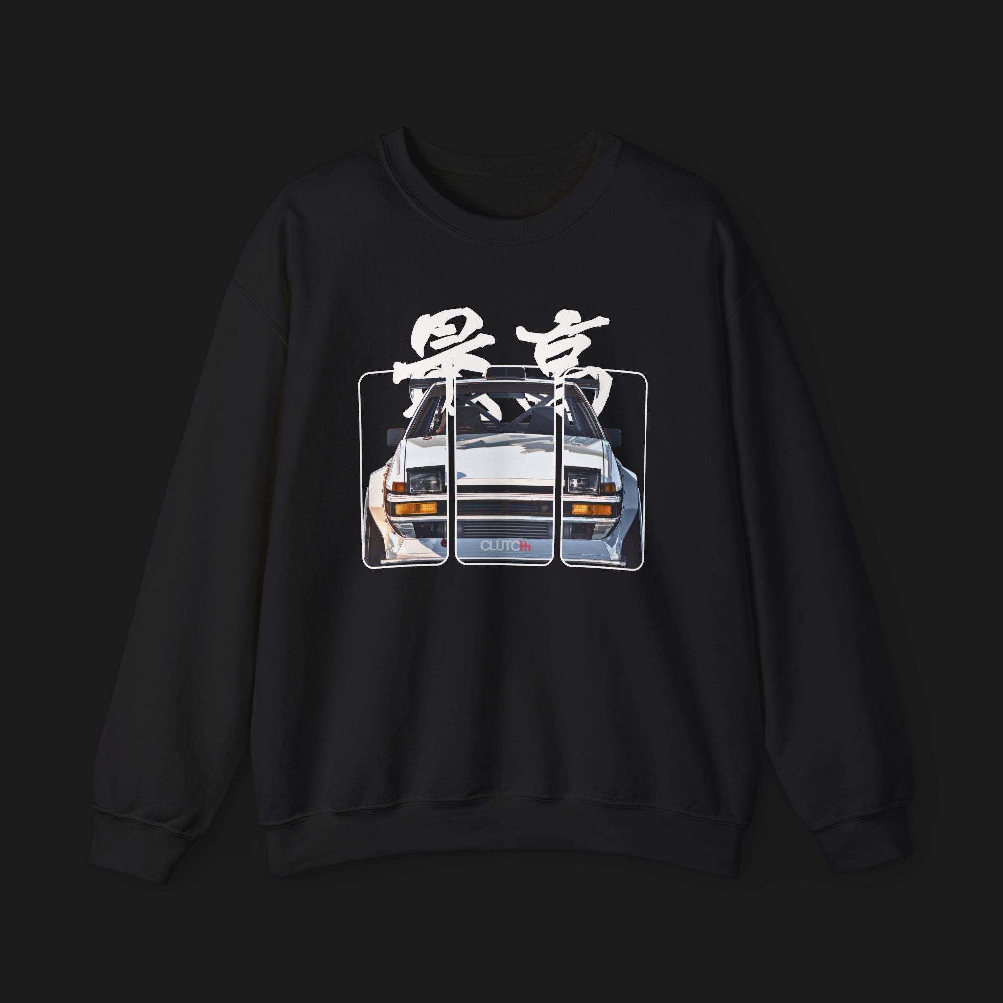 Front of AE86 Automotive Graphic Crewneck – Black unisex crewneck sweater featuring a front graphic of a white AE86 car with red Japanese text background design. Perfect for JDM enthusiasts and car lovers.