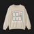 Front of Clutch Classic Automotive Graphic Crewneck – Beige unisex crewneck sweater featuring a retro 'Clutch' logo with a bold outlined design in red, blue, and white. Perfect for car enthusiasts and casual wear.