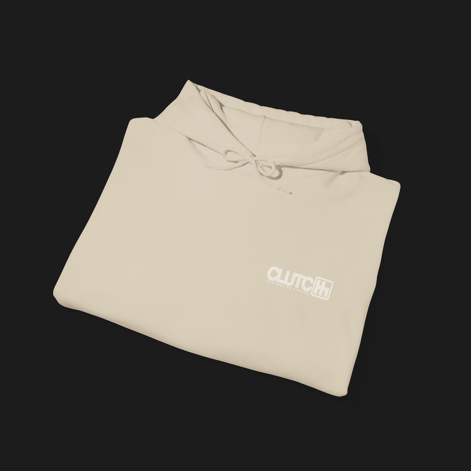Folded front Clutch Clothing Unisex Automotive Graphic Hoodie – Beige hoodie featuring a bold 'Clutch' logo with a stylized 'H' shifter design and script text overlay. Ideal for car enthusiasts and casual streetwear."