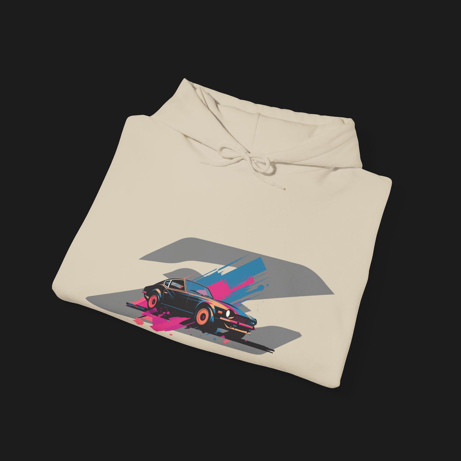 Folded Front Retro 280Z Automotive Graphic Hoodie – Beige unisex hoodie featuring a colorful retro design of a Nissan 280Z with vibrant pink, blue, and gray geometric background. Ideal for classic JDM and car lovers.