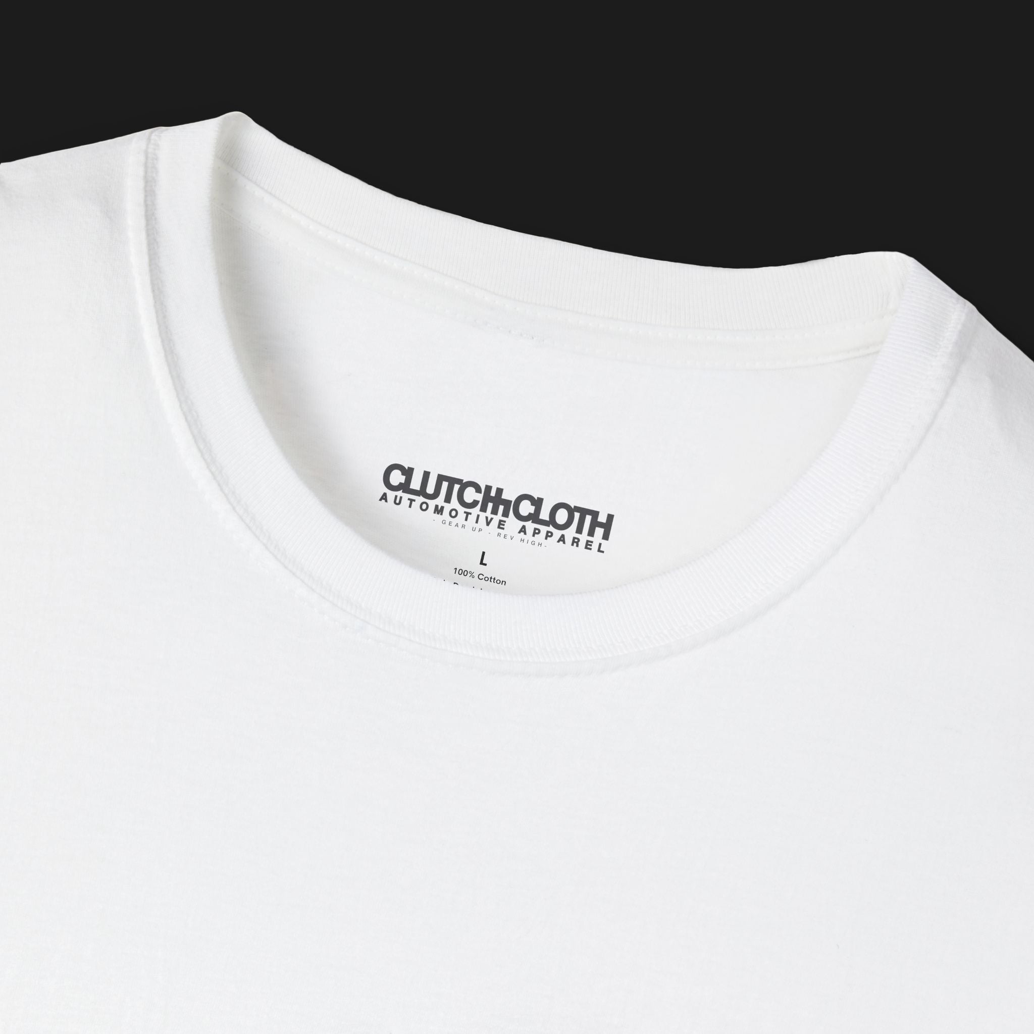 collar of Clutch Classic Unlock The Garage Automotive Graphic T-Shirt – White tee featuring a small "Clutch Automotive Apparel" chest design. Perfect gift for car lovers and gearheads.