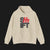 Front of SHIFT - ClutchCloth Classic Automotive Pullover Hoodie – Beige unisex hoodie featuring bold black and red 'SHIFT' graphic with a stylized clutch design. Ideal for car lovers and streetwear fans