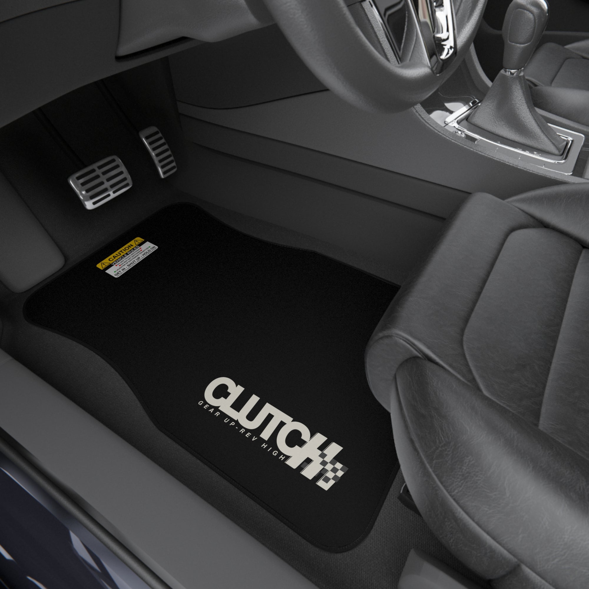 Clutch Car Mat Set – Front Left Premium set of black car mats featuring the Clutch logo and "Gear Up, Rev High" tagline Displayed in the front seat of a car. Designed for durability and style, perfect for automotive enthusiasts.