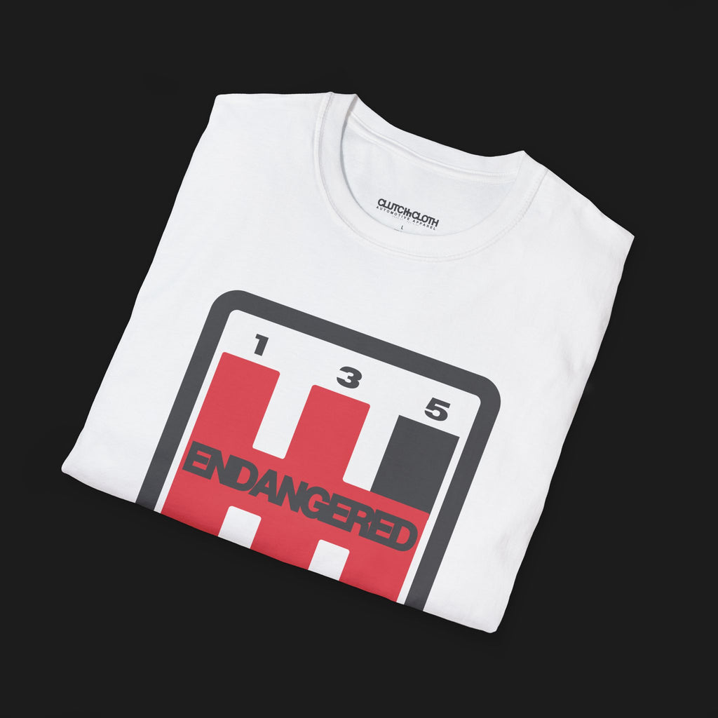 Folded Endangered Species Shifter Automotive Graphic T-Shirt – White unisex tee featuring a bold manual gear shift design with 'Endangered' text. A perfect gift for stick shift enthusiasts and car lovers.