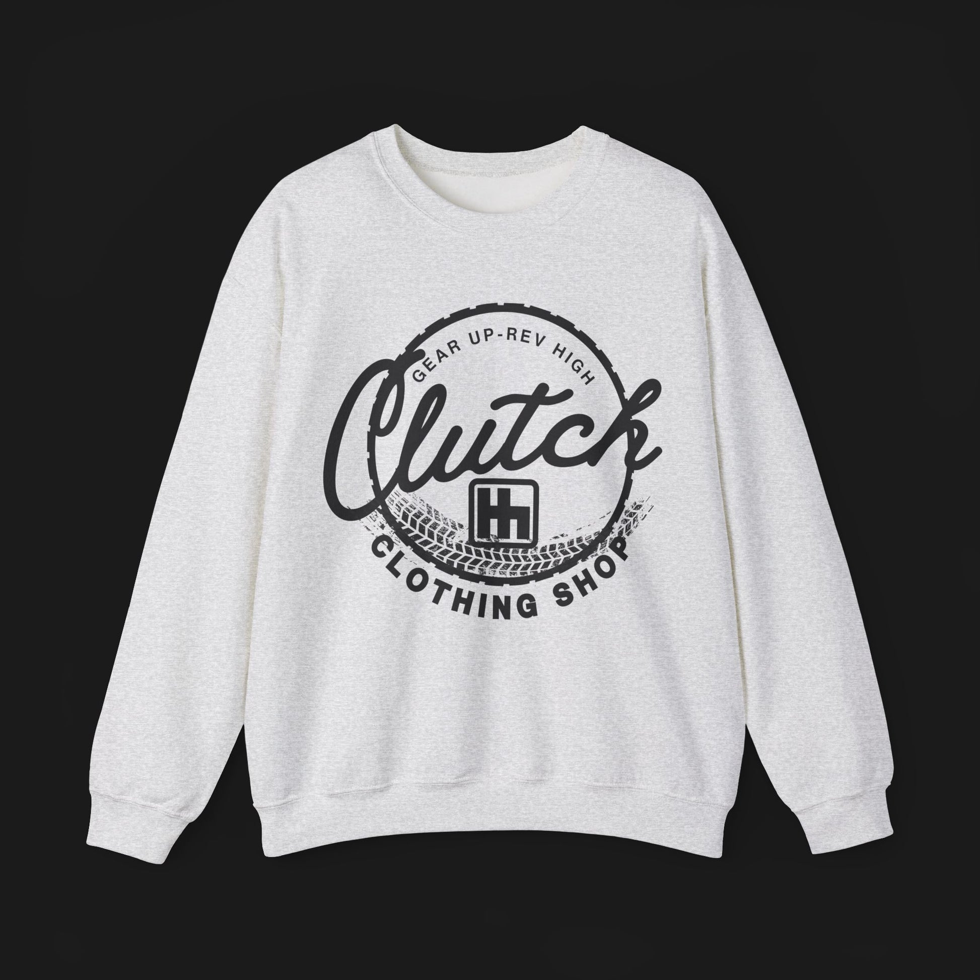 Front of Clutch Crewneck Automotive Sweater – Light grey unisex sweater featuring a bold 'Clutch Clothing Shop' design with a tire tread circle and stylized text. Perfect for car enthusiasts and casual wear.