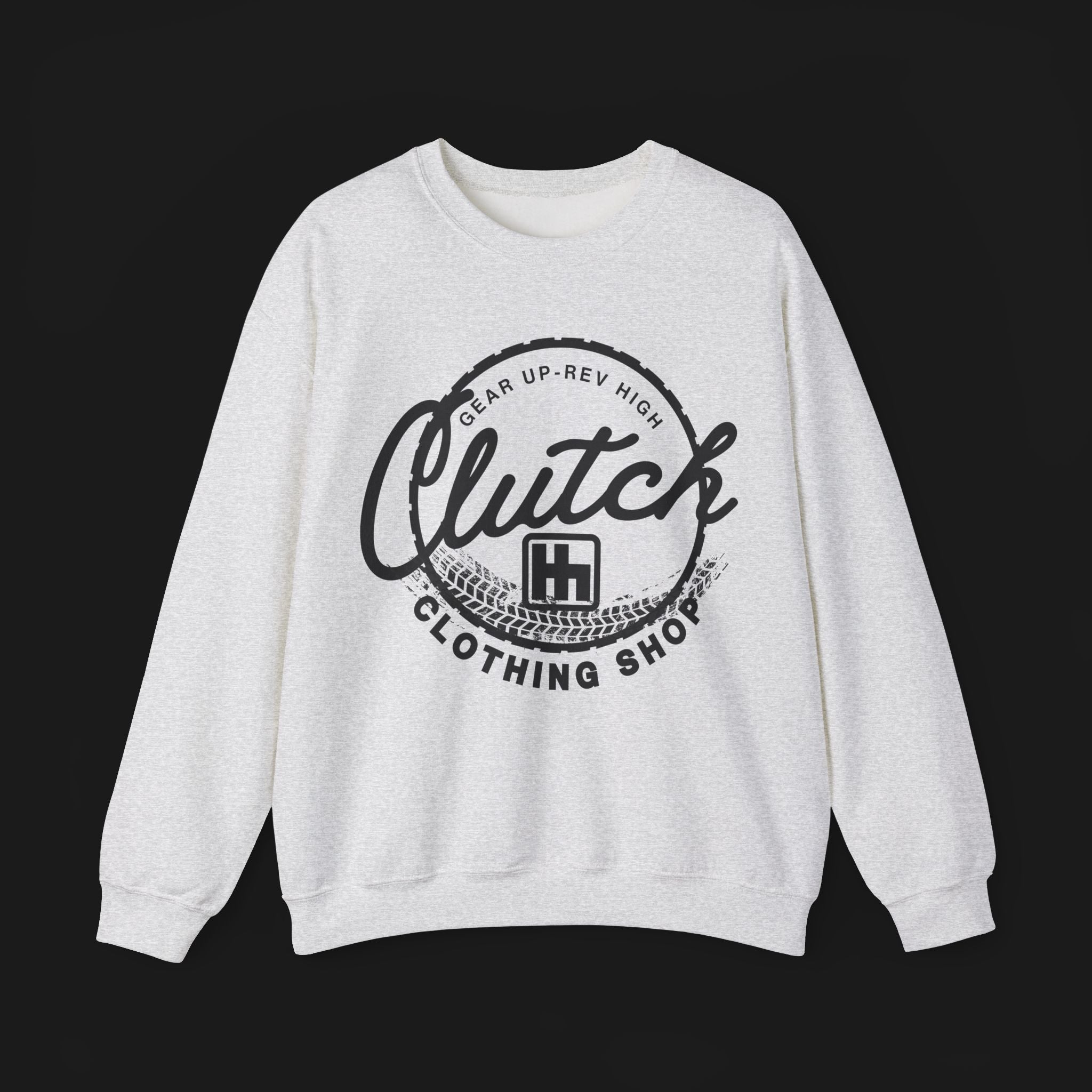 Front of Clutch Crewneck Automotive Sweater – Light grey unisex sweater featuring a bold 'Clutch Clothing Shop' design with a tire tread circle and stylized text. Perfect for car enthusiasts and casual wear.