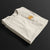 Folded Astonishingly Overkill Automotive Graphic T-Shirt – Beige tee featuring a bold Audi Quattro rally car design with a yellow overlay and "Astonishingly Overkill" text. Perfect gift for rally fans and car enthusiasts.