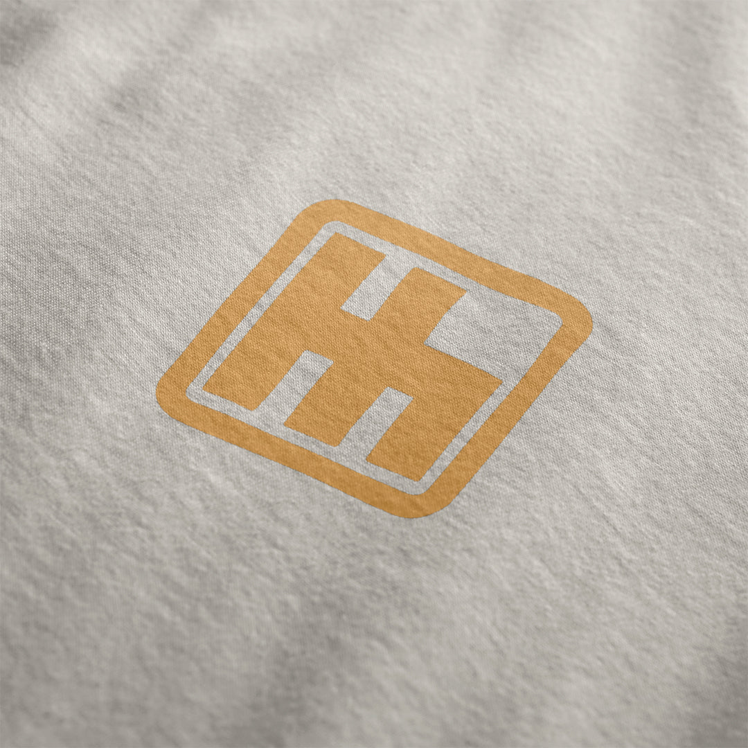 Front Design for Astonishingly Overkill Automotive Graphic T-Shirt – Beige tee featuring a bold Audi Quattro rally car design with a yellow overlay and "Astonishingly Overkill" text. Perfect gift for rally fans and car enthusiasts.
