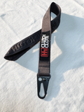 Black and gray strap with brand logo on a light blue background