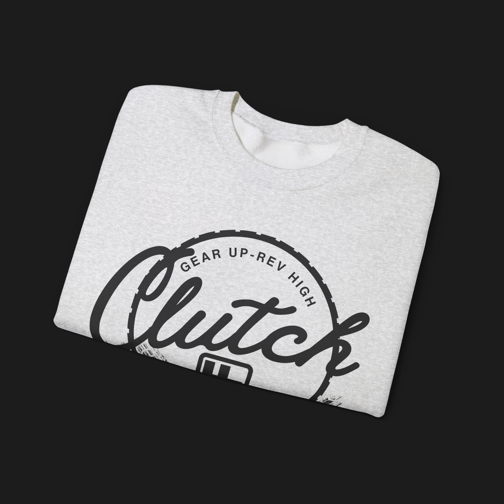 Folded Clutch Crewneck Automotive Sweater – Light grey unisex sweater featuring a bold 'Clutch Clothing Shop' design with a tire tread circle and stylized text. Perfect for car enthusiasts and casual wear.