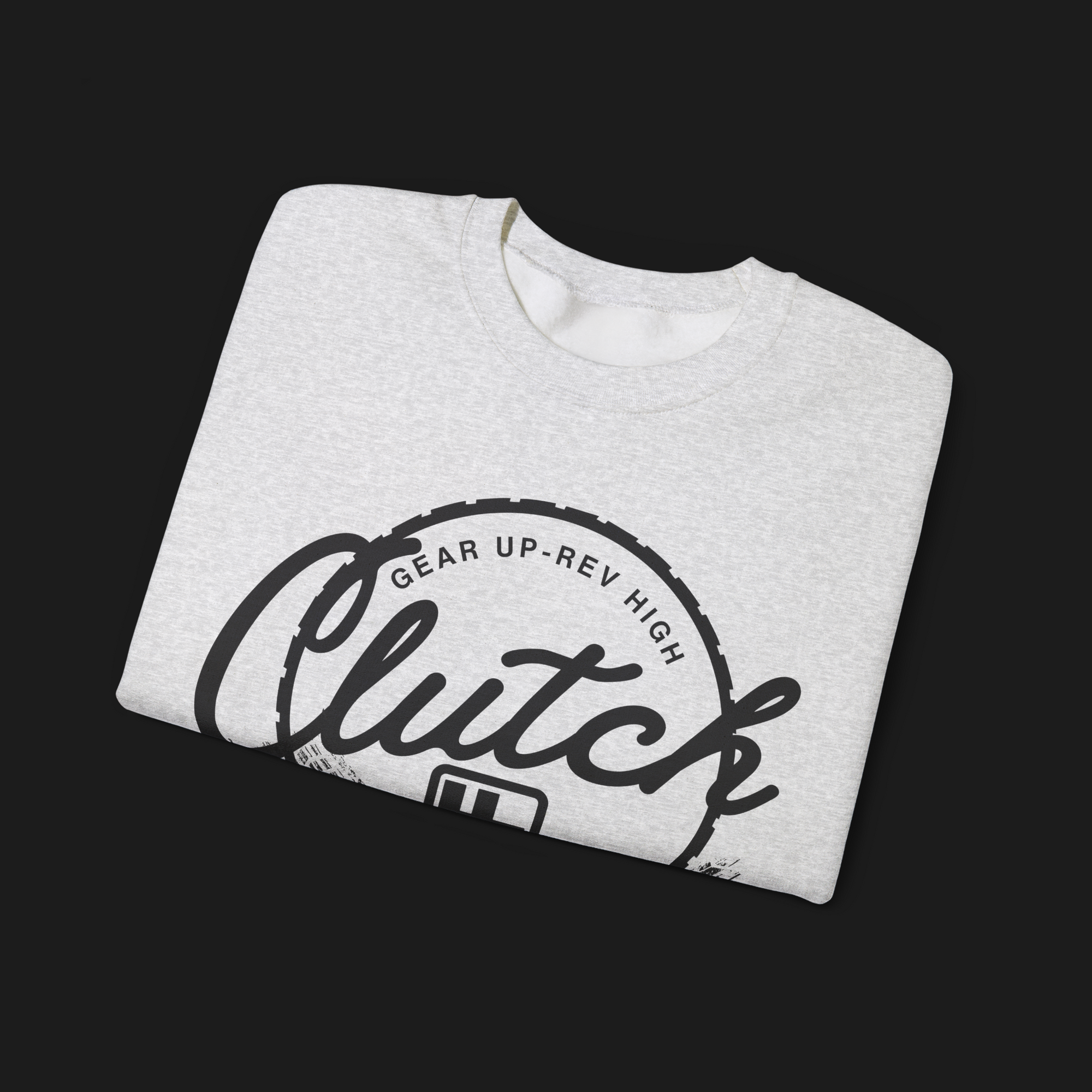 Folded Clutch Crewneck Automotive Sweater – Light grey unisex sweater featuring a bold 'Clutch Clothing Shop' design with a tire tread circle and stylized text. Perfect for car enthusiasts and casual wear.