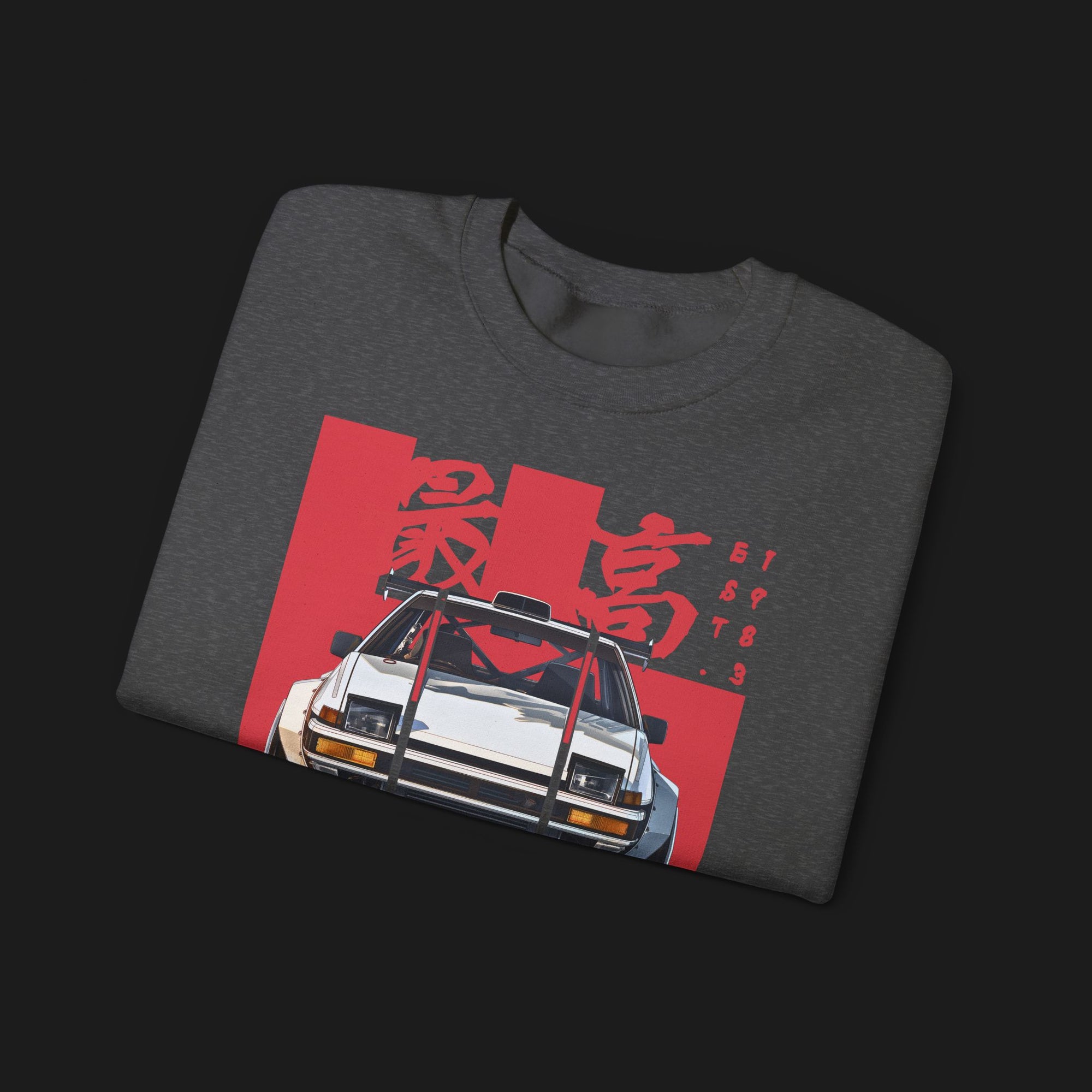 Folded AE86 Automotive Graphic Crewneck – Dark grey unisex crewneck sweater featuring a front graphic of a white AE86 car with red Japanese text background design. Perfect for JDM enthusiasts and car lovers.