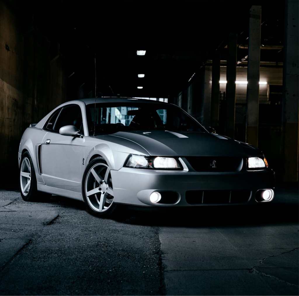 Ford Mustang Cobra SVT Terminator Clutch parked in a dark, urban setting with lights on
