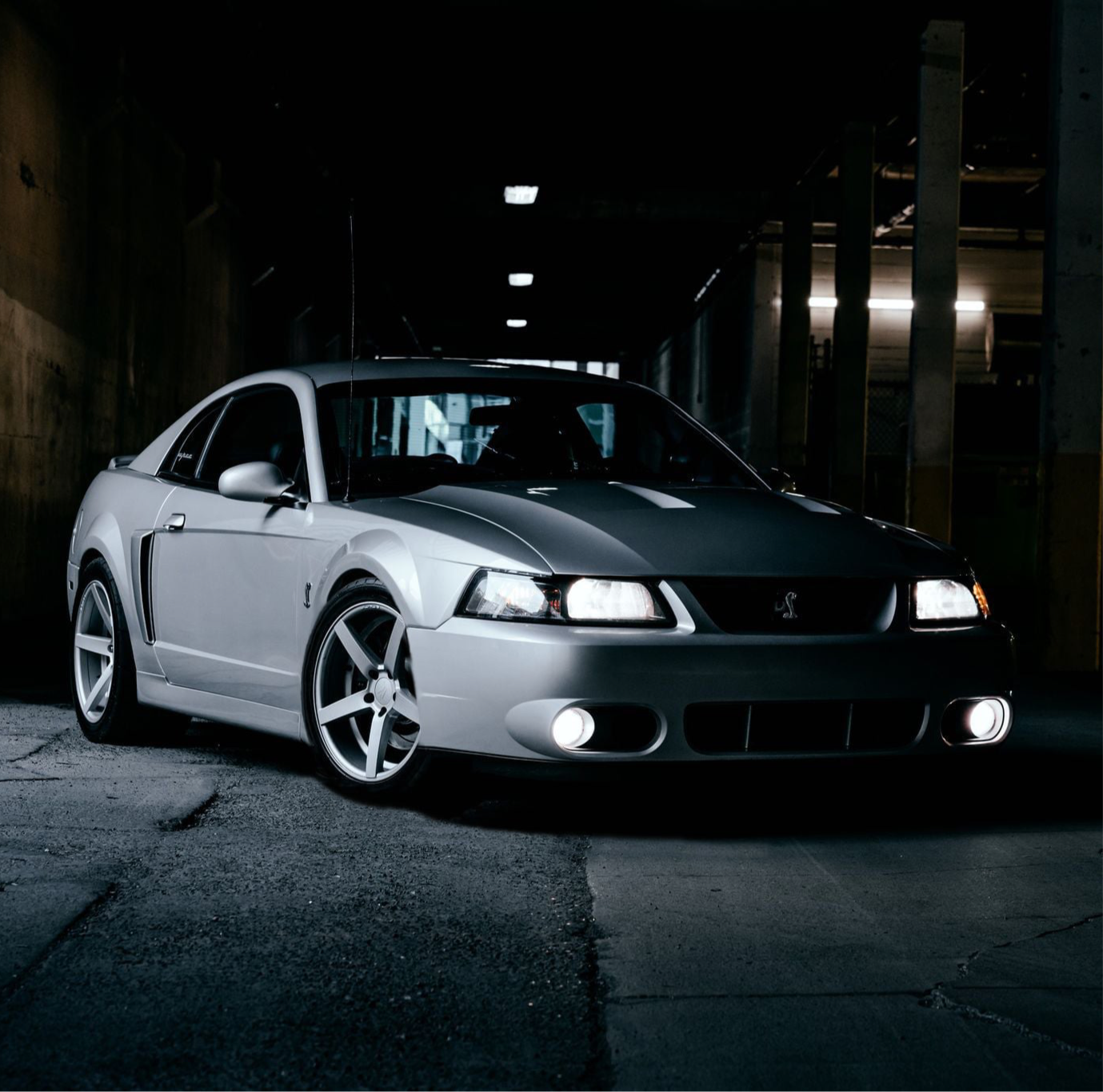 Ford Mustang Cobra SVT Terminator Clutch parked in a dark, urban setting with lights on