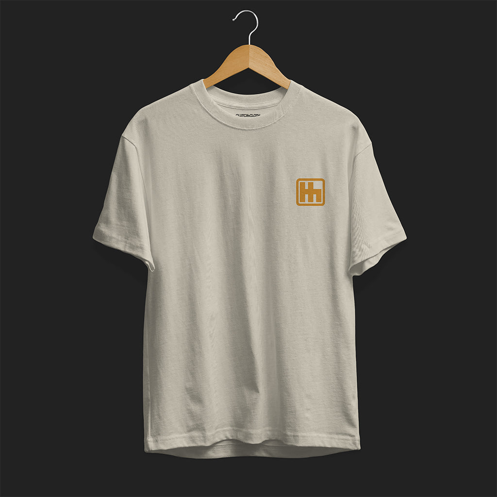 Front Angle of Astonishingly Overkill Automotive Graphic T-Shirt – Beige tee featuring a bold Audi Quattro rally car design with a yellow overlay and "Astonishingly Overkill" text. Perfect gift for rally fans and car enthusiasts.