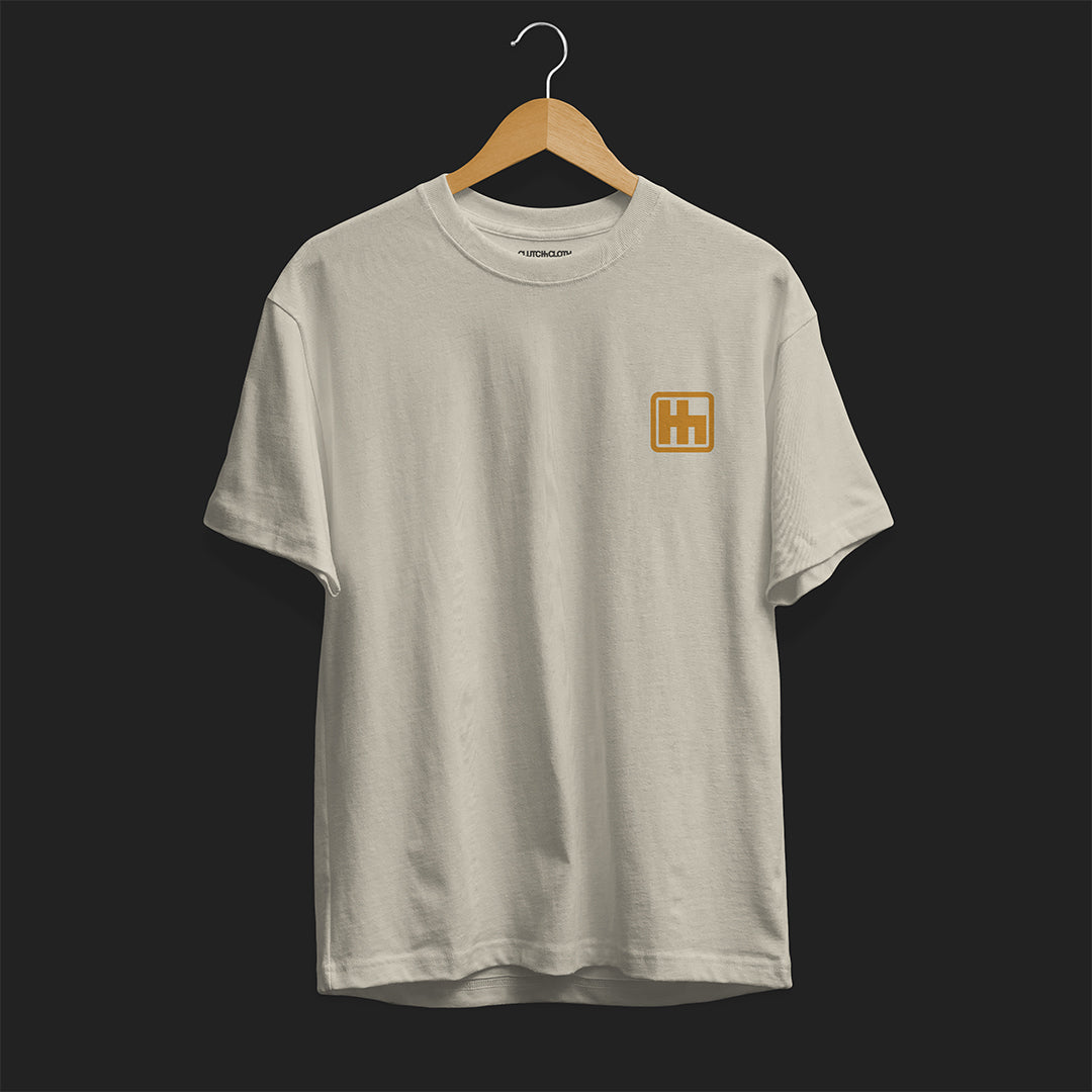 Front Angle of Astonishingly Overkill Automotive Graphic T-Shirt – Beige tee featuring a bold Audi Quattro rally car design with a yellow overlay and "Astonishingly Overkill" text. Perfect gift for rally fans and car enthusiasts.