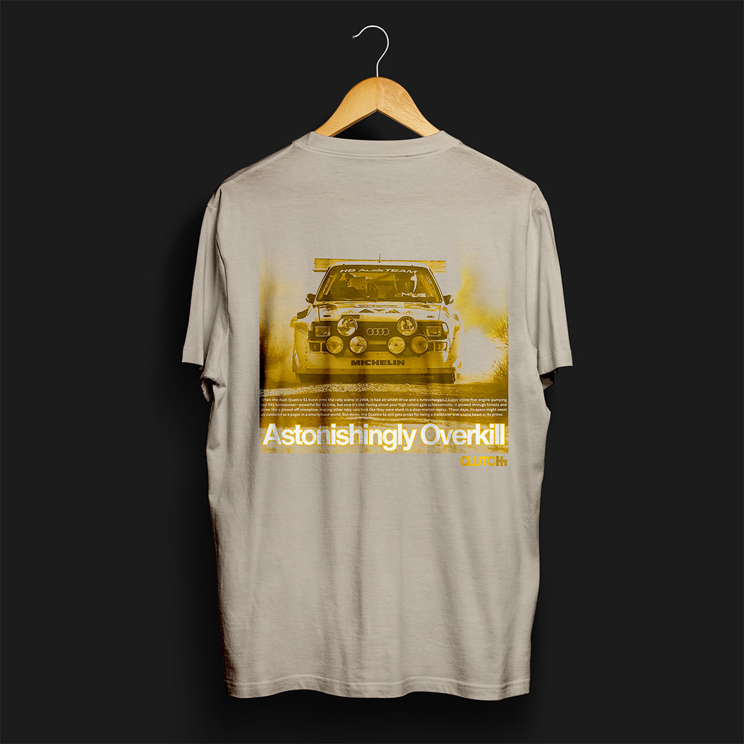 Back of Astonishingly Overkill Automotive Graphic T-Shirt – Sand tee featuring a bold Audi Quattro rally car design with a yellow overlay and "Astonishingly Overkill" text. Perfect gift for rally fans and car enthusiasts.