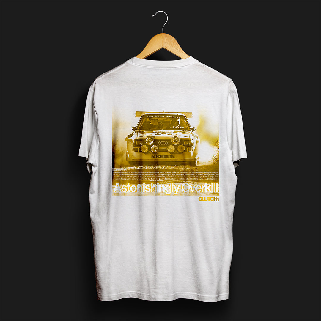 Front of Astonishingly Overkill Automotive Graphic T-Shirt – White tee featuring a bold Audi Quattro rally car design with a yellow overlay and "Astonishingly Overkill" text. Perfect gift for rally fans and car enthusiasts.