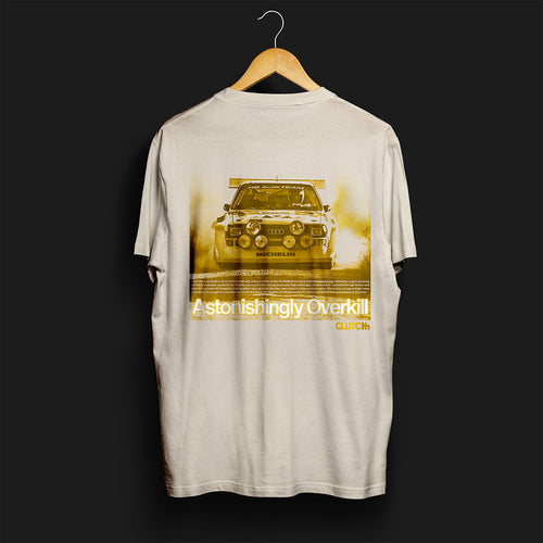 Back Angle of Astonishingly Overkill Automotive Graphic T-Shirt – Beige tee featuring a bold Audi Quattro rally car design with a yellow overlay and "Astonishingly Overkill" text. Perfect gift for rally fans and car enthusiasts.