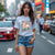 Woman wearing 280Z Travel Japan Automotive Graphic T-Shirt – Light Grey tee featuring a vintage Datsun 280Z with Japanese travel-inspired artwork. Perfect gift for JDM fans, car enthusiasts, and retro automotive lovers.