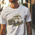 Man wearing Volks Retro Life Automotive Graphic T-Shirt – White unisex tee featuring a vintage rusted car overgrown with flowers. A unique gift for car enthusiasts and retro automotive lovers.