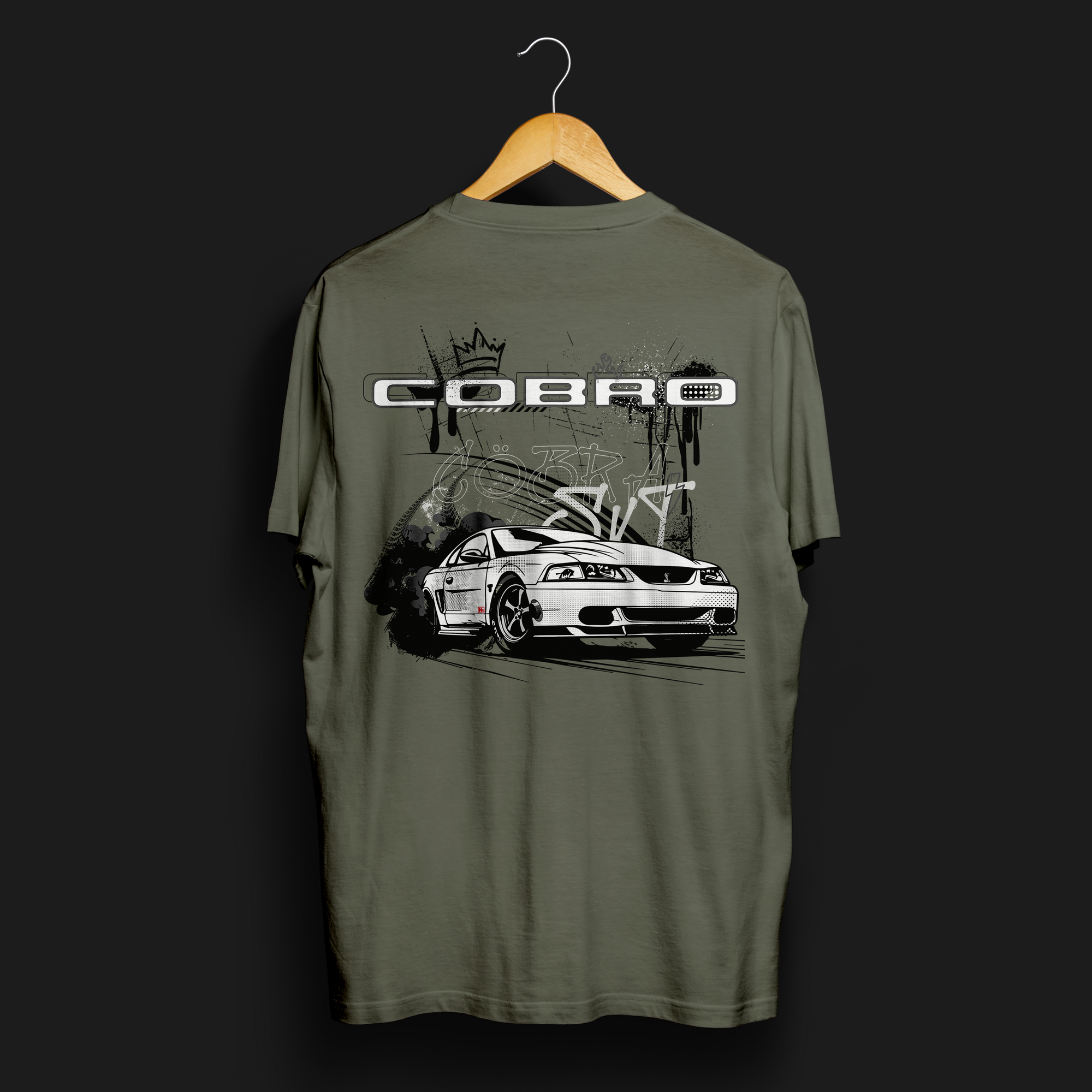Back angle of Cobro x Clutch Automotive Graphic T-Shirt – Green tee featuring a detailed white Mustang Cobra design with graffiti-style background and "Cobro" text. Perfect gift for Mustang fans and car enthusiasts.