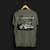 Back angle of Cobro x Clutch Automotive Graphic T-Shirt – Green tee featuring a detailed white Mustang Cobra design with graffiti-style background and "Cobro" text. Perfect gift for Mustang fans and car enthusiasts.