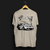 Back angle of Cobro x Clutch Automotive Graphic T-Shirt – Sand tee featuring a detailed white Mustang Cobra design with graffiti-style background and "Cobro" text. Perfect gift for Mustang fans and car enthusiasts.