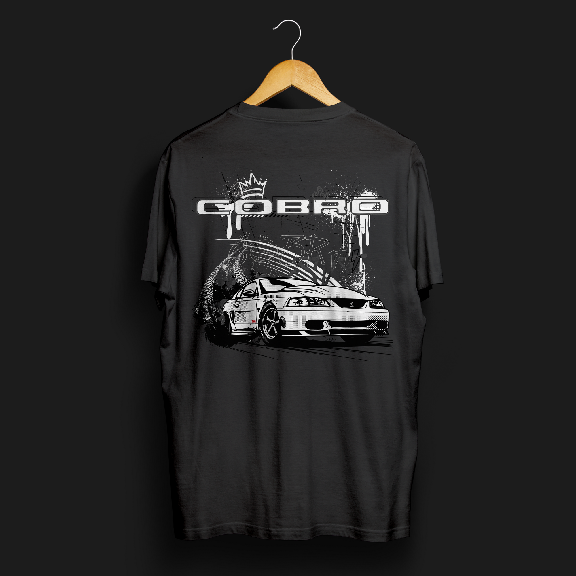 Back angle of Cobro x Clutch Automotive Graphic T-Shirt – Black tee featuring a detailed white Mustang Cobra design with graffiti-style background and "Cobro" text. Perfect gift for Mustang fans and car enthusiasts.