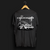 Back angle of Cobro x Clutch Automotive Graphic T-Shirt – Black tee featuring a detailed white Mustang Cobra design with graffiti-style background and "Cobro" text. Perfect gift for Mustang fans and car enthusiasts.