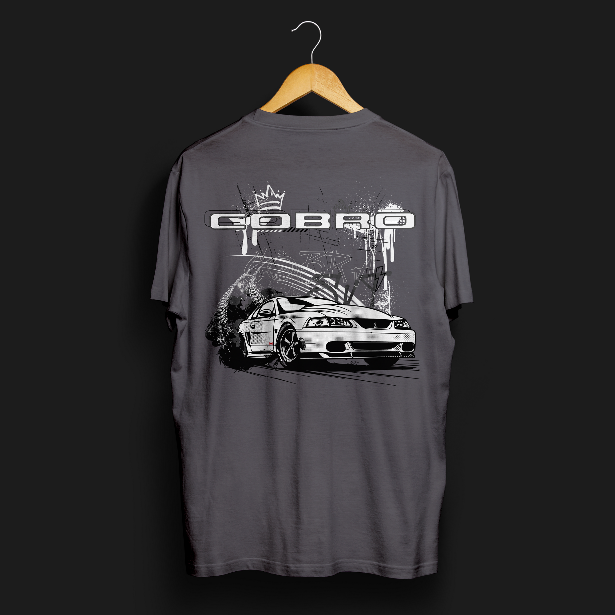 Back angle of Cobro x Clutch Automotive Graphic T-Shirt – Charcoal tee featuring a detailed white Mustang Cobra design with graffiti-style background and "Cobro" text. Perfect gift for Mustang fans and car enthusiasts.