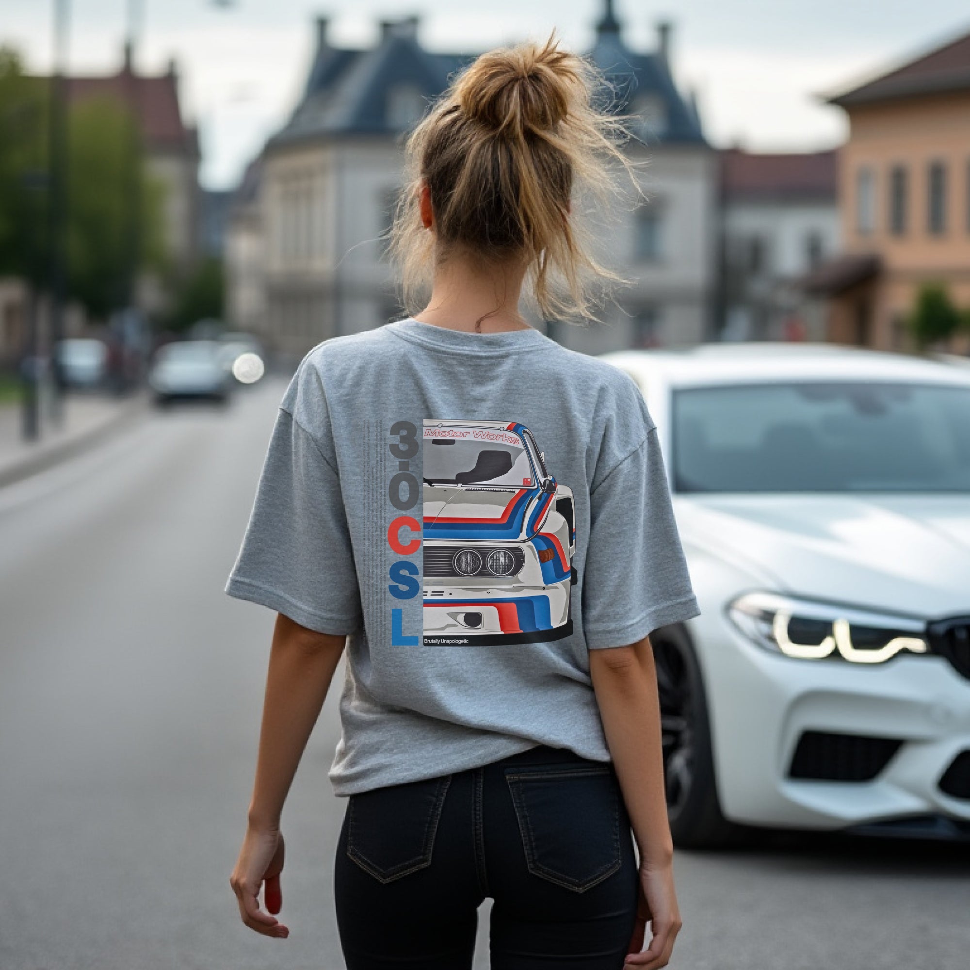 Brutally Unapologetic 30CSL Automotive Graphic T-Shirt – White tee featuring a detailed front design of the iconic BMW 30CSL with red, blue, and white racing stripes. Perfect gift for BMW fans and car enthusiasts.
