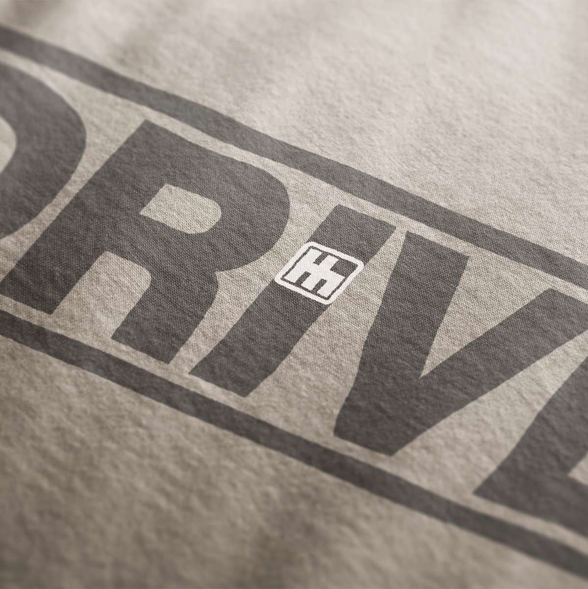 Close up design for Drive Automotive Graphic T-Shirt – Sand color tee featuring bold "DRIVE" text with gear-inspired detailing. Perfect gift for car enthusiasts and racing fans.