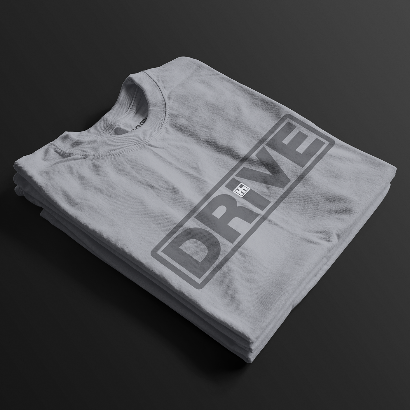 Folded Drive Automotive Graphic T-Shirt – Ice White tee featuring bold "DRIVE" text with gear-inspired detailing. Perfect gift for car enthusiasts and racing fans.