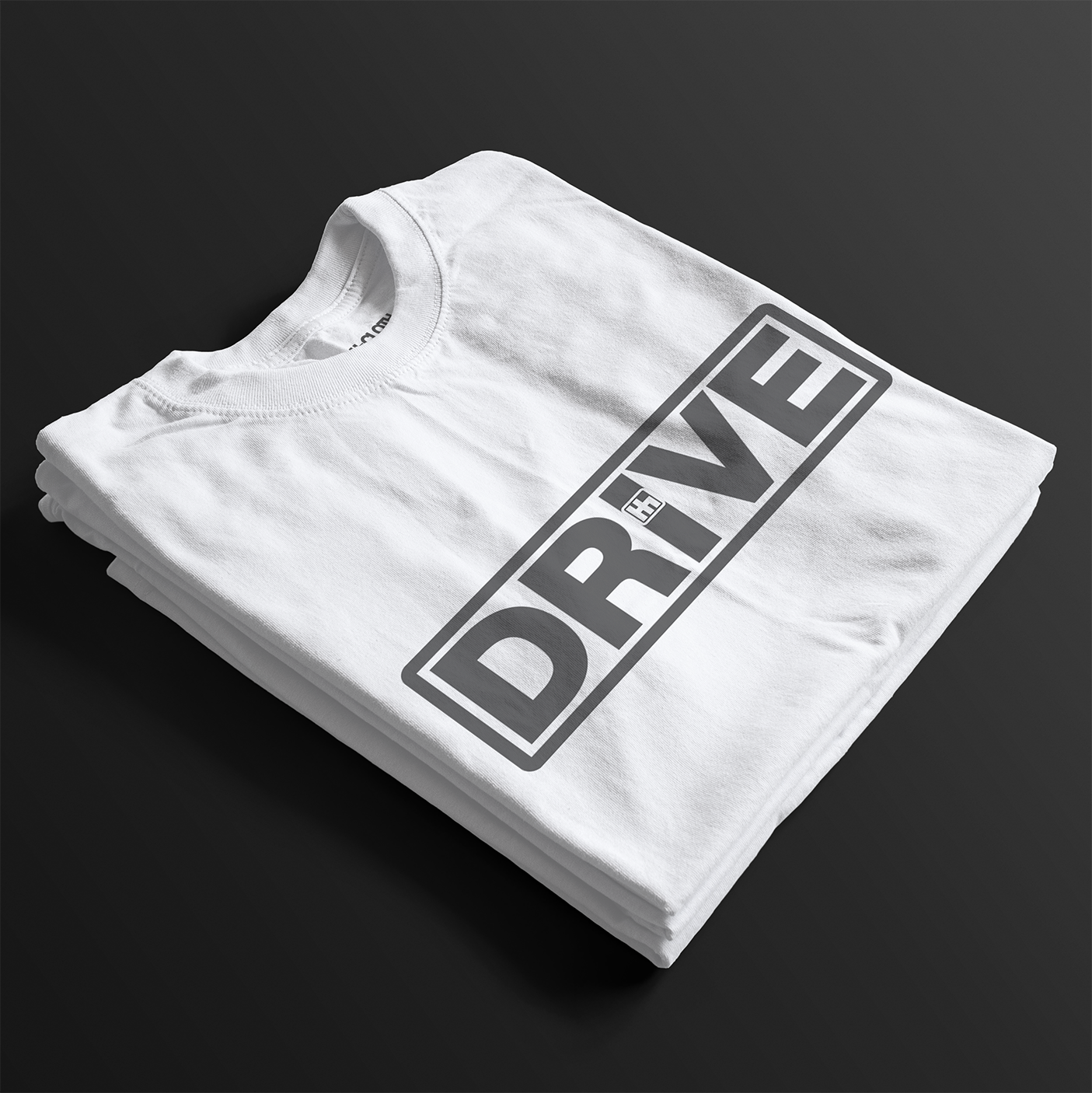 Folded Drive Automotive Graphic T-Shirt – White tee featuring bold "DRIVE" text with gear-inspired detailing. Perfect gift for car enthusiasts and racing fans.
