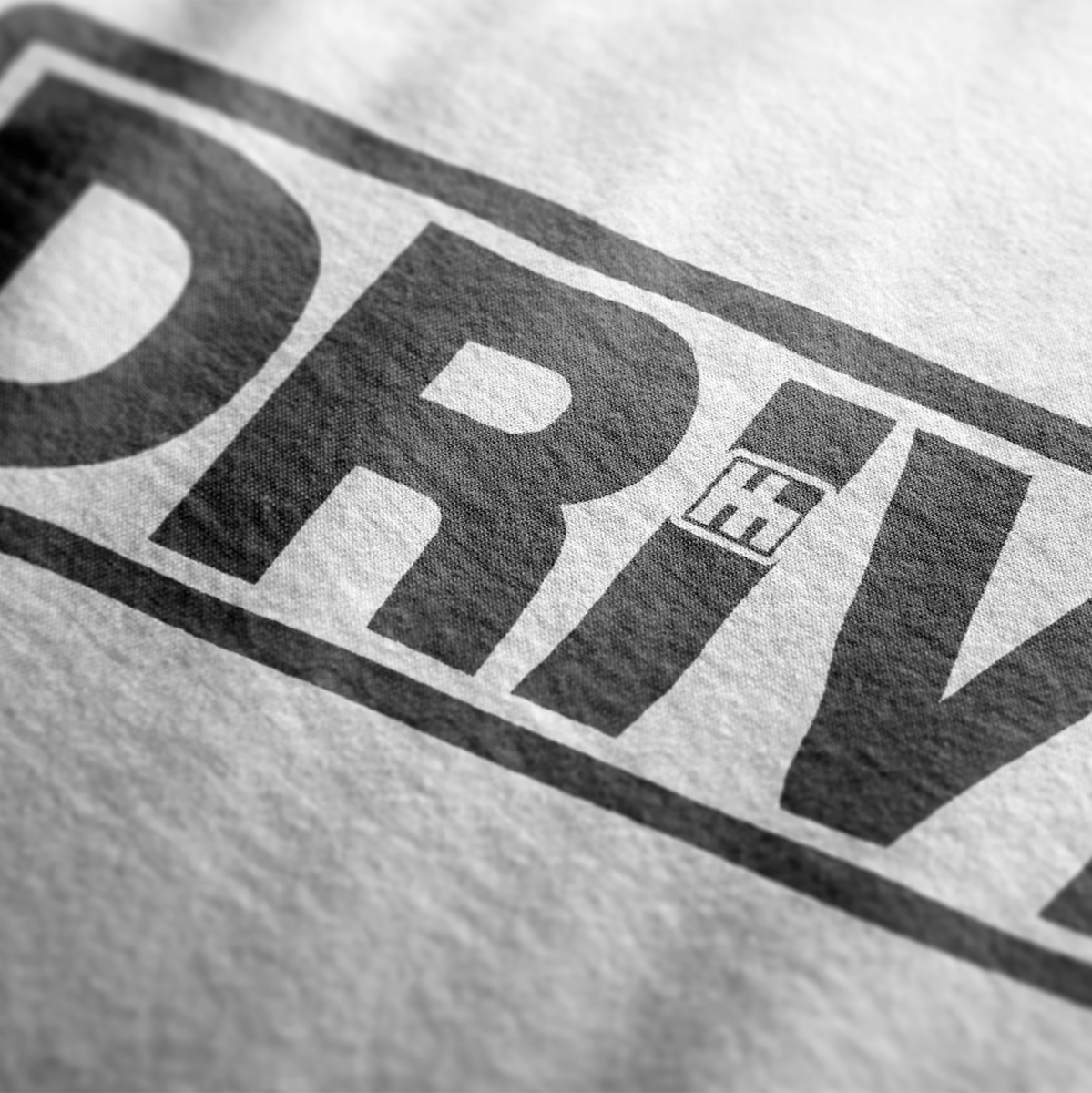 Close up design for Drive Automotive Graphic T-Shirt – White tee featuring bold "DRIVE" text with gear-inspired detailing. Perfect gift for car enthusiasts and racing fans.