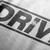 Close up design for Drive Automotive Graphic T-Shirt – White tee featuring bold "DRIVE" text with gear-inspired detailing. Perfect gift for car enthusiasts and racing fans.