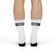 Back of man wearing Driving Lessons Crew Socks – White and black unisex crew socks featuring "GAS" and "CLUTCH" labels on the toes and heel. Comfortable and stylish, designed for automotive enthusiasts. Ideal gift or stocking stuffer for men and women who love cars and driving culture