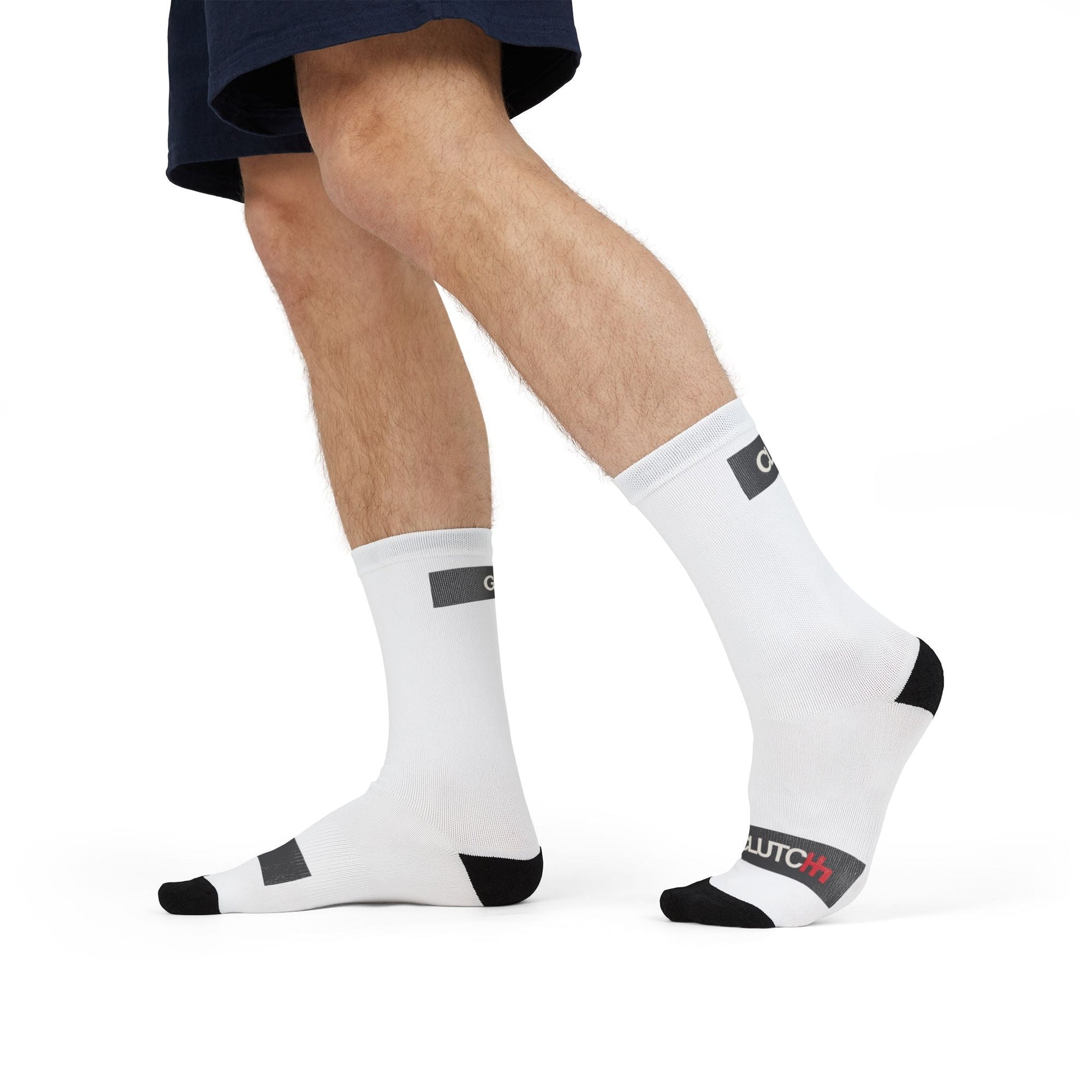 Man wearing Driving Lessons Crew Socks – White and black unisex crew socks featuring "GAS" and "CLUTCH" labels on the toes and heel. Comfortable and stylish, designed for automotive enthusiasts. Ideal gift or stocking stuffer for men and women who love cars and driving culture