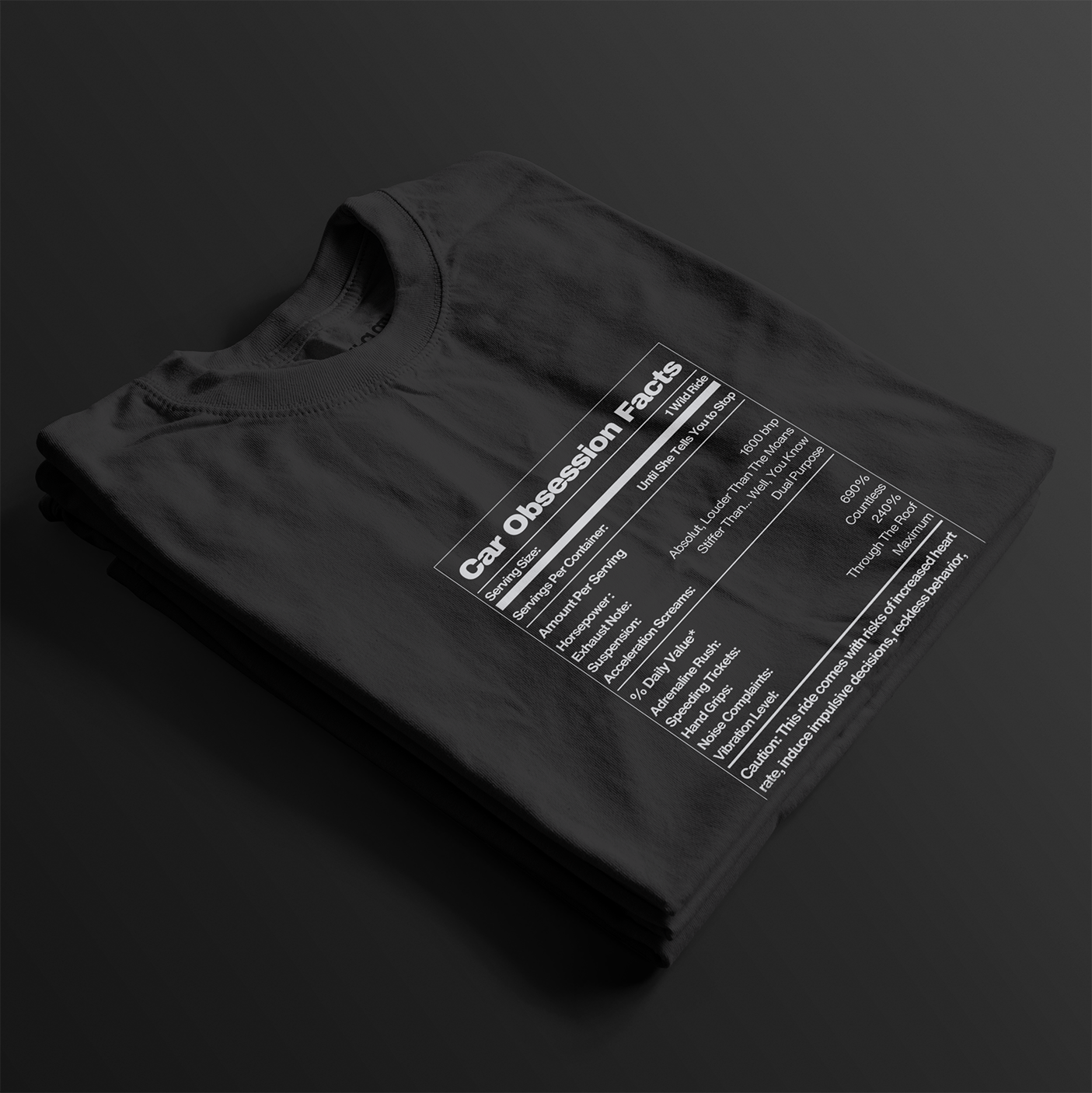 Folded Car Obsession Facts Automotive Graphic T-Shirt – Black unisex tee featuring a humorous 'Car Obsession Facts' label with details on horsepower, speed, and side effects. Ideal gift for car lovers and automotive enthusiasts.
