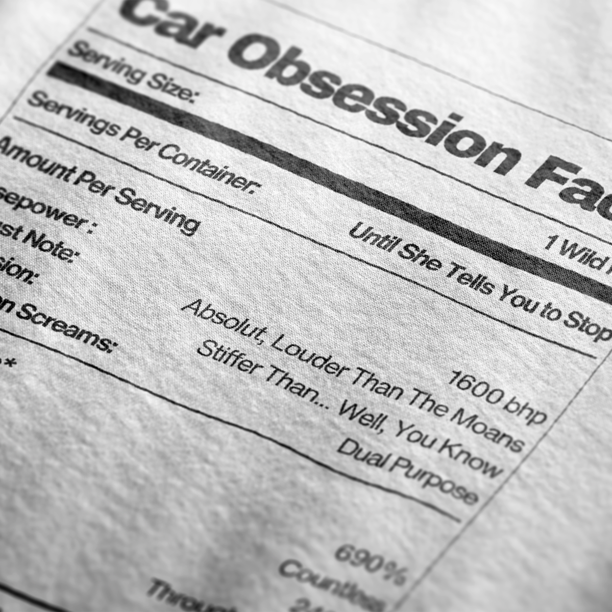 Close up of Car Obsession Facts Automotive Graphic T-Shirt Design – White unisex tee featuring a humorous 'Car Obsession Facts' label with details on horsepower, speed, and side effects. Ideal gift for car lovers and automotive enthusiasts.